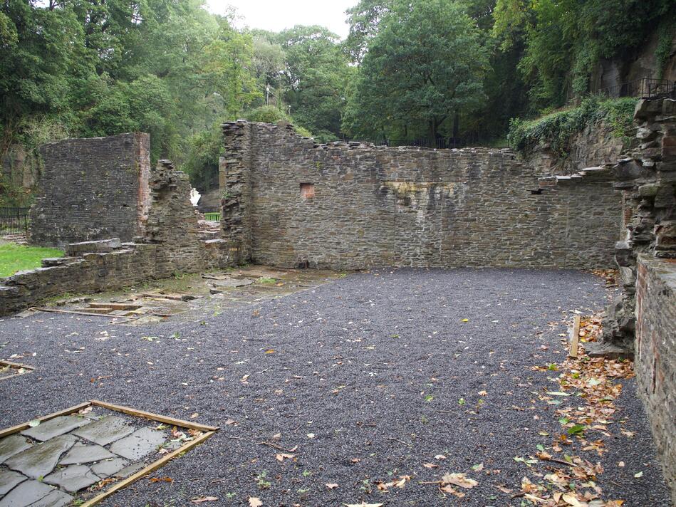 Looking into a room, with some stone-plated areas on the floor.